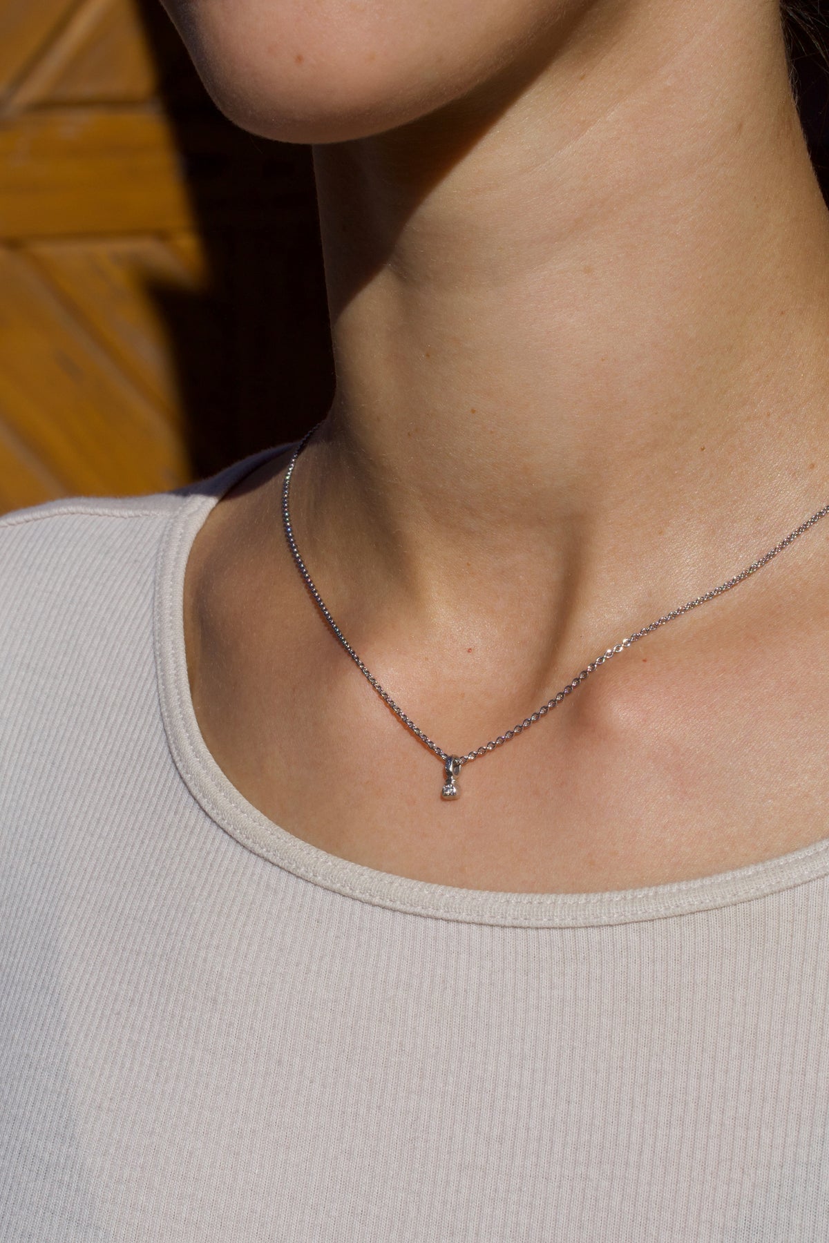 Zarter Würfelanhänger aus 750 Weißgold mit Lab Grown Diamant (0,02 ct), getragen